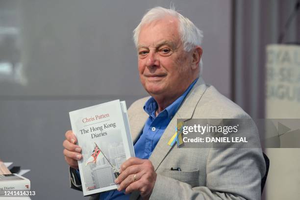 Former Hong Kong governor Lord Chris Patten, poses with his new book "The Hong Kong Diaries" at the end of a press conference to present it, in...