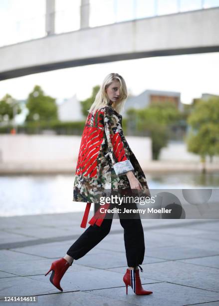 Trixi Giese wearing Off white jacket, Steve Madden heels, Urban Outfitters pants and Bershka red top on May 26, 2020 in Berlin, Germany.