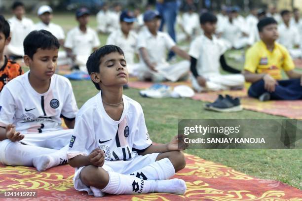 Youth take part in a yoga practice session on the eve of International Yoga Day, in Allahabad on June 20, 2022.