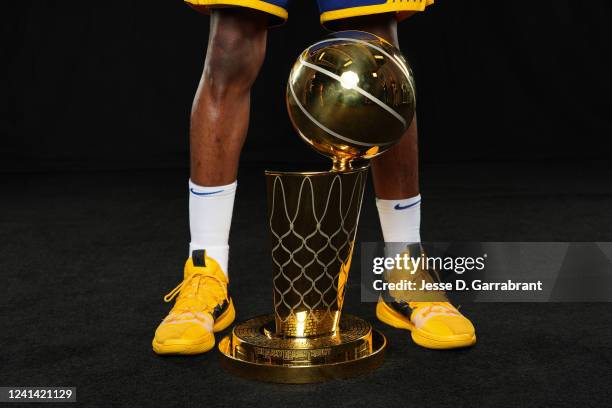 Andrew Wiggins of the Golden State Warriors poses with the Larry O'Brien NBA Championship Trophy after winning game 6 of the NBA finals against the...