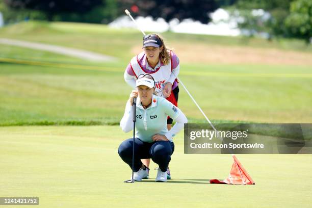 Golfer Brooke Henderson and her sister caddie Brittany Henderson line up a putt on the 9th hole during the Meijer LPGA Classic For Simply Give on...