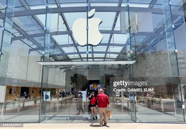 Customers enter the Apple Store on the Third Street Promenade in Santa Monica, California on June 19, 2022.