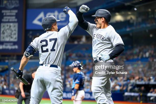 Giancarlo Stanton and Anthony Rizzo of the New York Yankees celebrate Rizzo's home run off Shane McClanahan of the Tampa Bay Rays in the first inning...