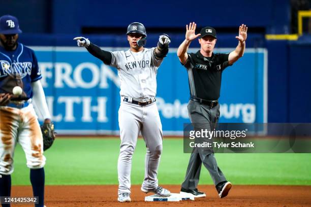 Gleyber Torres of the New York Yankees celebrates a double by drawing a heart in the air toward the dugout in the seventh inning against the Tampa...