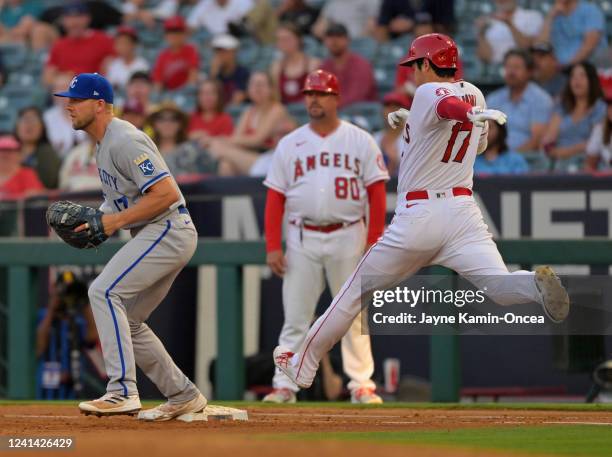 Shohei Ohtani of the Los Angeles Angels beats the throw to Hunter Dozier of the Kansas City Royals for a single in the third inning at Angel Stadium...
