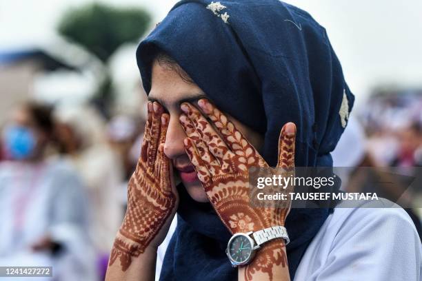 Woman participates in a mass yoga session near the Dal Lake to celebrate the International Day of Yoga in Srinagar on June 21, 2022.