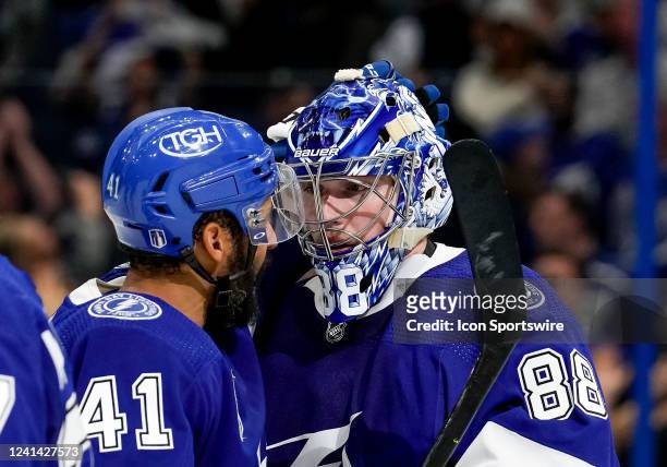 Tampa Bay Lightning left wing Pierre-Edouard Bellemare and Tampa Bay Lightning goaltender Andrei Vasilevskiy celebrate the win during the NHL Hockey...