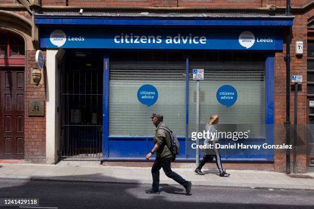 Members of the public pass by a city centre branch of Citizens Advice, an independent charitable organisation offering support to the British public...
