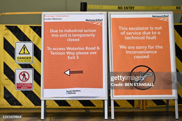 Signs announce an exit is closed at Waterloo Station in London on June 21, 2022 as the biggest rail strike in over 30 years hits the UK. Rush-hour...