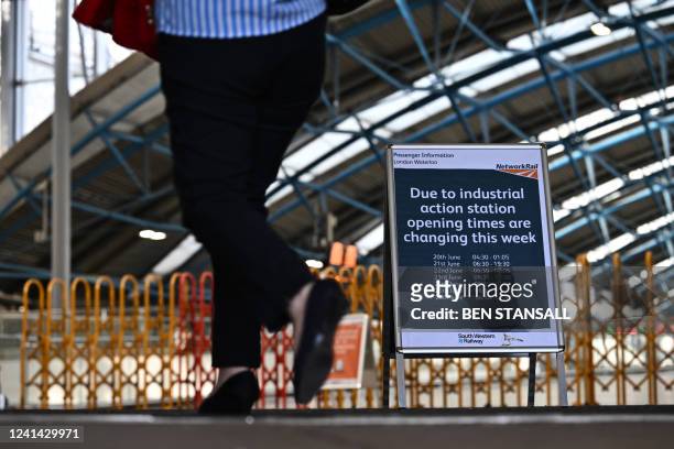 Sign announces different opening times at Waterloo Station in London on June 21, 2022 as the biggest rail strike in over 30 years hits the UK....