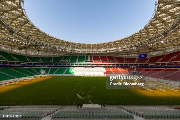 Grounds crew water the grass pitch surface of the Al Thumama football stadium in Doha, Qatar, on Monday, June 20, 2022. The stadium will be a venue...