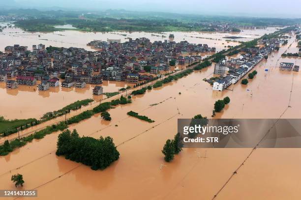 This aerial photo taken on June 21, 2022 shows a flooded area after heavy rains in Shangrao, in China's central Jiangxi province. - China OUT / China...