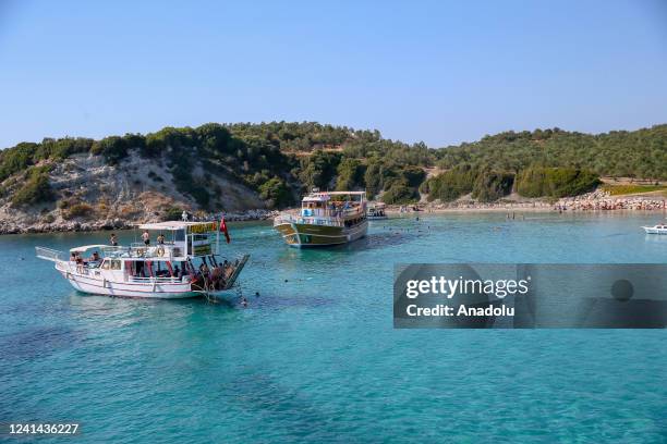 Tour boats are seen on the shore of Northern Aegean Region in Izmir, Turkiye on June 21, 2022. With its 40 km long beach and healing thermal springs,...