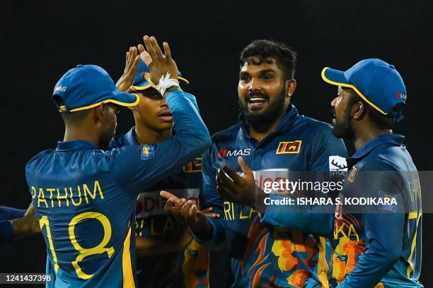 Sri Lanka's Wanindu Hasaranga celebrates after taking the wicket of Australia's Alex Carey during the fourth one-day international cricket match...