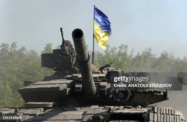 Ukrainian troop ride a tank on a road of the eastern Ukrainian region of Donbas on June 21 as Ukraine says Russian shelling has caused "catastrophic...