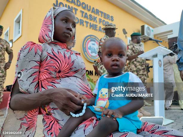 Kidnapped Chibok schoolgirl Hauwa Joseph sits with her baby at Maimalari Barracks in Maiduguri, northeast Nigeria, on June 21, 2022. - Nigerian...