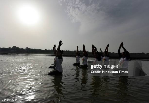 Water Sports players participating in yoga inside the water in eighth international yoga day organised by Sonia Bihar water sports club at Yamuna...