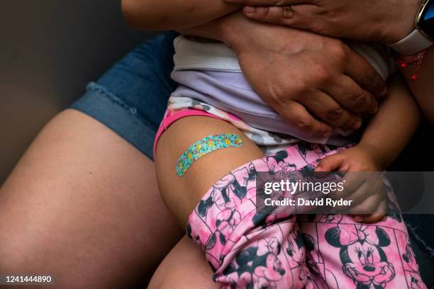 Two-year-old wears a bandage after receiving her first dose of the Pfizer Covid-19 vaccination at UW Medical Center - Roosevelt on June 21, 2022 in...