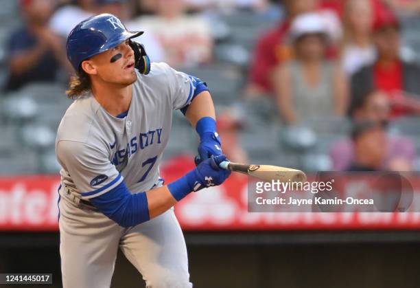 Bobby Witt Jr. #7 of the Kansas City Royals watches as the ball clears the wall for a solo home run in the first inning of the game against the Los...