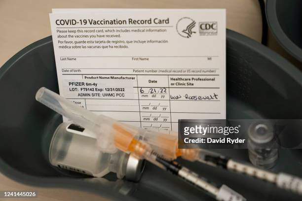 Doses of the Pfizer Covid-19 vaccine and vaccination record cards await patients at UW Medical Center - Roosevelt on June 21, 2022 in Seattle,...