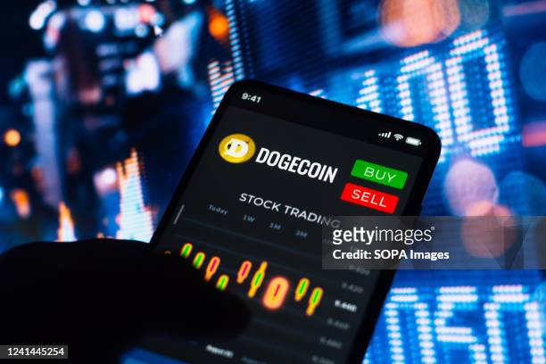 In this photo illustration, the stock trading graph of Dogecoin seen on a smartphone screen.