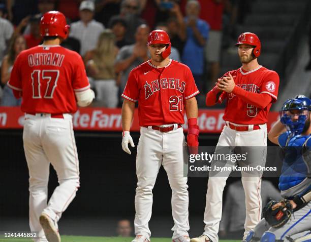 Shohei Ohtani of the Los Angeles Angels crosses the plate after hitting a 3-run home run scoring Mike Trout and Taylor Ward in the sixth inning of...