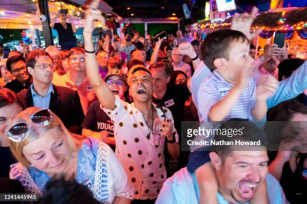 Supporters of Yesli Vega celebrate following her Republican primary win for the 7th Congressional District during an election night event on June 21,...