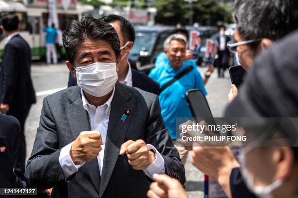 Former Japanese prime minister Shinzo Abe interacts with supporters as he joins the election campaign for Liberal Democratic Party member Kentaro...