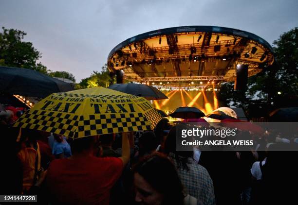 People watch as MC Solaar performs at the Capitol One City Parks Foundation SummerStage in New York on June 21, 2022. - The concert is part of the...