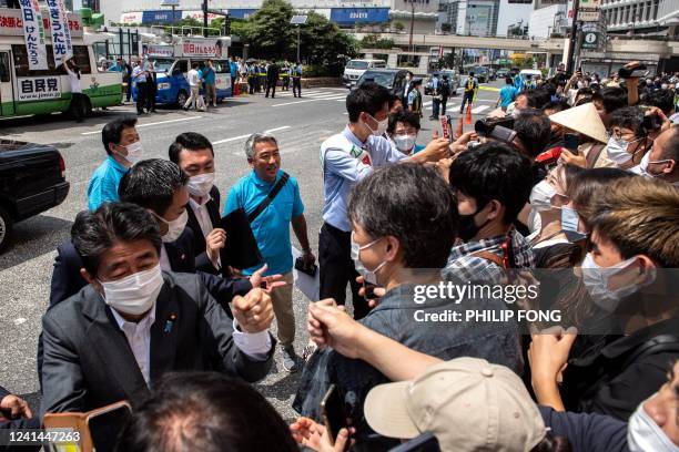 Former Japanese prime minister Shinzo Abe interacts with supporters as he joins the election campaign for Liberal Democratic Party member Kentaro...