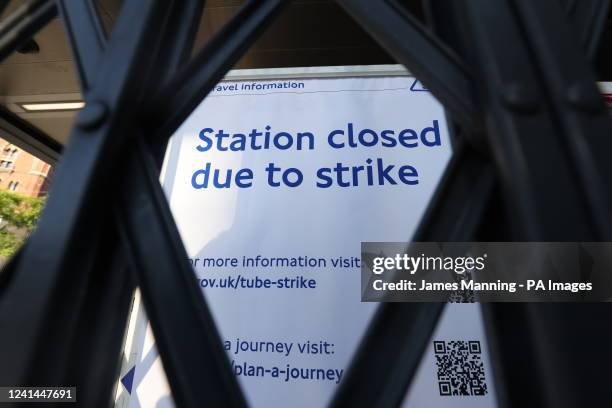 Sign can be seen through a closed gate at King's Cross St. Pancras underground station in London, as train services continue to be disrupted...