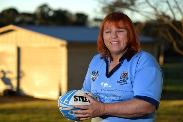 Transgender former rugby player Caroline Layt poses for pictures with a rugby ball in her house backyard in Sydney on June 22, 2022. - The Australian...