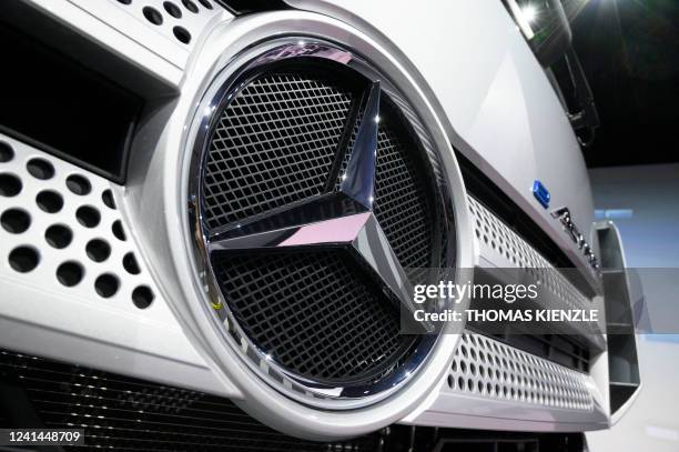 The Daimler logo is seen on the front of an e-Actros truck at the company's annual shareholders' meeting in Stuttgart, southern Germany, on June 22,...
