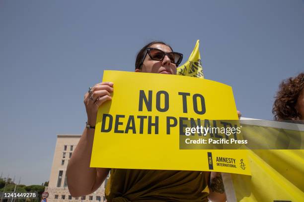 Activist holding placard No to Death Penalty. Amnesty International activists protest in front of Foreign Ministry against four death sentences...