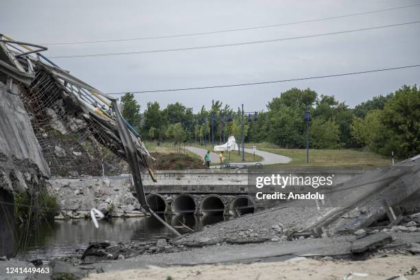 Civilians walk near by a bridge that was destroyed in Irpin on last February during the fighting between Ukrainian forces with Russian troops, Irpin,...