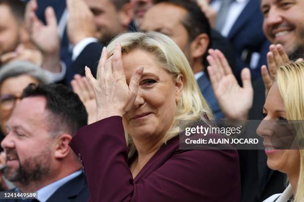 French far-right Rassemblement National leader and Member of Parliament Marine Le Pen poses with Members of Parliament for a family picture at the...