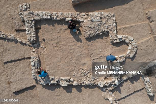 An aerial view shows Palestinian workers of Israel's Antiquities Authority during work at a recently discovered ancient mosque, which dates back to...