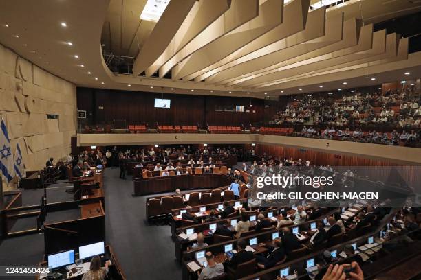 Lawmakers attend a preliminary vote on a bill to dissolve parliament and call an early election, at the Knesset in Jerusalem on June 22, 2022.