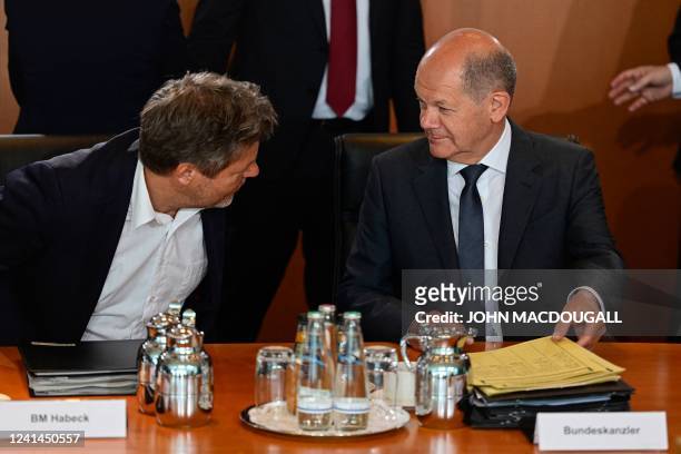 German Minister of Economics and Climate Protection Robert Habeck and German Chancellor Olaf Scholz chat prior to the start of the weekly cabinet...