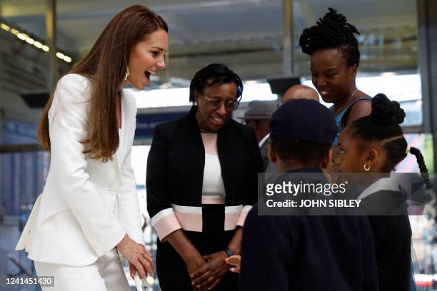 Britain's Catherine , Duchess of Cambridge, speaks to guests as she attends the unveiling of the National Windrush Monument at Waterloo Station in...