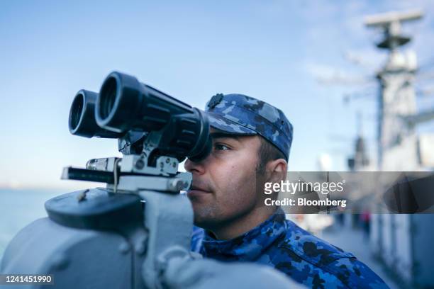 Serviceman uses mounted binoculars on board the Romanian Navy King Ferdinand frigate during the Shield Protector 22 military exercise in the Black...