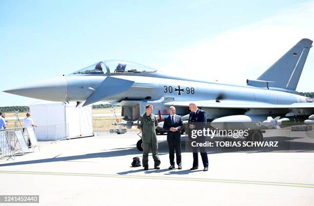 German Chancellor Olaf Scholz , Lieutenant General of the German Air Force Ingo Gerhartz and German Air Force pilot Stefan Schneemilch pose in front...