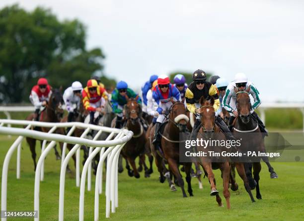 Invincibly ridden by Clifford Lee passes Tommy G ridden by Paul Mulrennan to win the Stablemate By Agma Carlisle Bell Handicap at Carlisle...