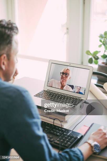 businesspeople having a video call working at home - two people video conferencing stock pictures, royalty-free photos & images