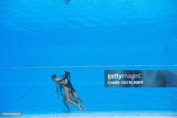 S coach Andrea Fuentes recovers USA's Anita Alvarez , from the bottom of the pool during an incident in the women's solo free artistic swimming...
