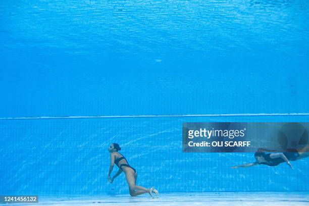 S coach Andrea Fuentes dives to save USA's Anita Alvarez , during an incident in the women's solo free artistic swimming finals during the Budapest...