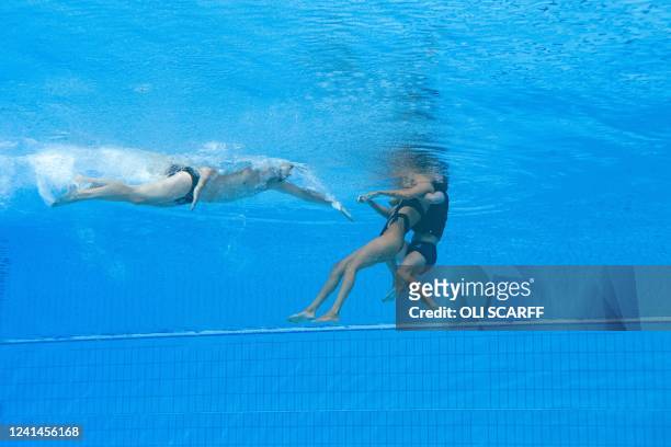 S coach Andrea Fuentes recovers USA's Anita Alvarez , from the bottom of the pool during an incident in the women's solo free artistic swimming...
