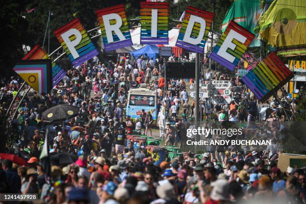 Festivalgoers arrive to attend the Glastonbury festival in the village of Pilton, in Somerset, South West England, on June 22, 2022. - More than...