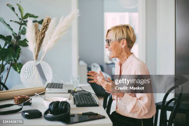 profile of woman attending video conference at home - profile laptop sitting stock pictures, royalty-free photos & images