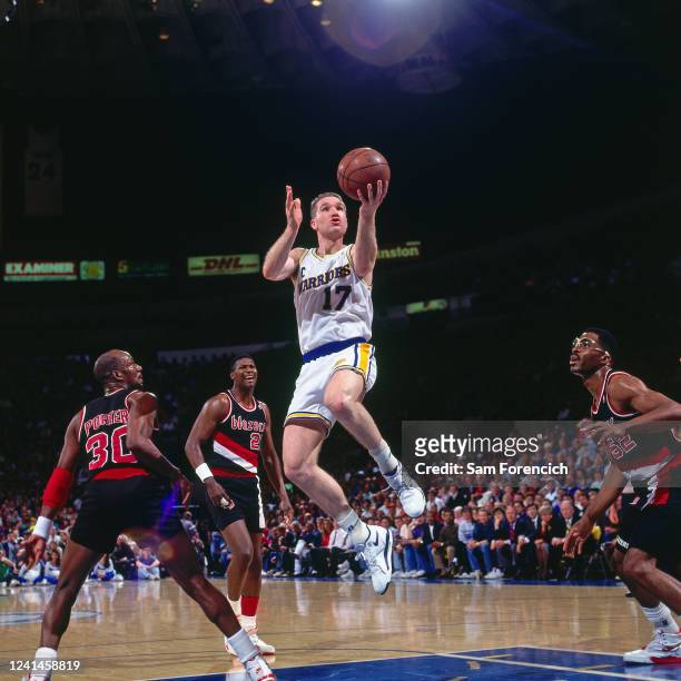 Chris Mullin of the Golden State Warriors drives to the basket during a game against the Portland Trail Blazers in 1992 at The Oakland-Alameda County...